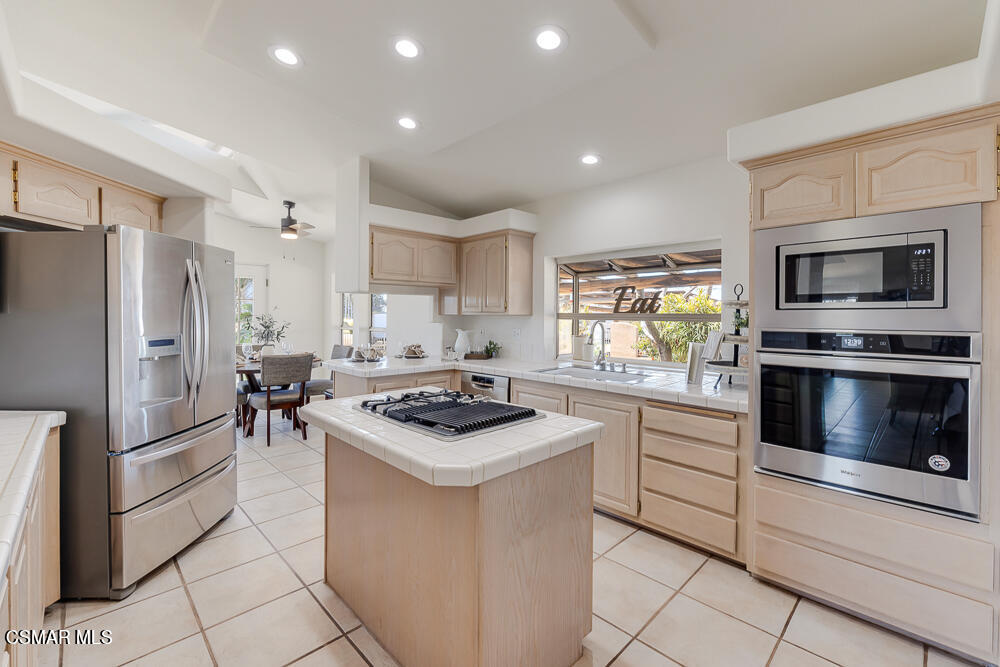 6500 Meadowglade Drive Moorpark, CA 93021 - Photo 24 of 64 a kitchen with a stove a sink and a refrigerator
