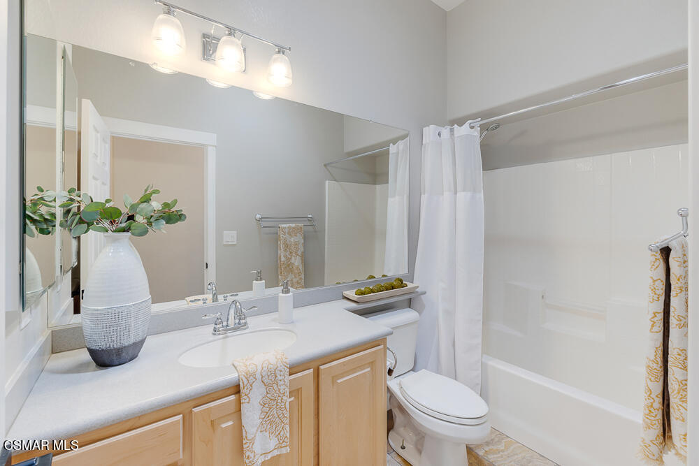 6500 Meadowglade Drive Moorpark, CA 93021 - Photo 55 of 64 a bathroom with a granite countertop sink a toilet a mirror and shower