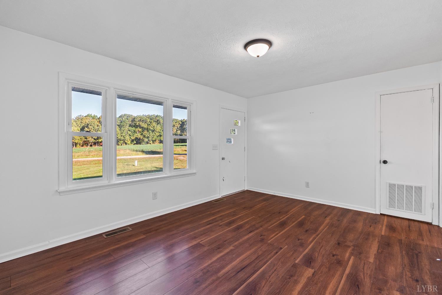 6068 Java Road Java, VA 24565 - Photo 3 of 43 an empty room with wooden floor and windows