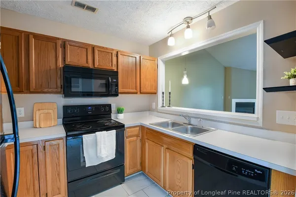 a kitchen with a refrigerator stove and microwave