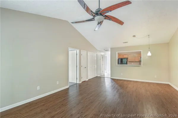 a view of an empty room with window and fire place