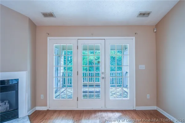 an empty room with a window and a ceiling fan