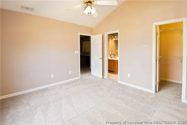 an empty room with a view of a livingroom with a large window
