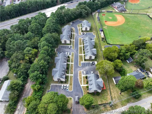 an aerial view of residential houses with outdoor space and street view
