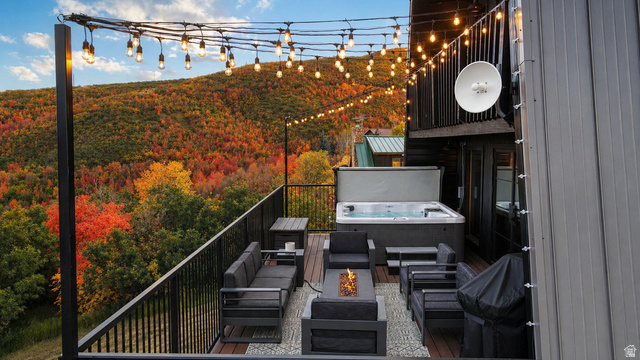 1413 Basel Drive Midway, UT 84049 - Photo 129 of 137 View of patio / terrace with a hot tub, a wooded view, an outdoor living space with a fire pit, and area for grilling