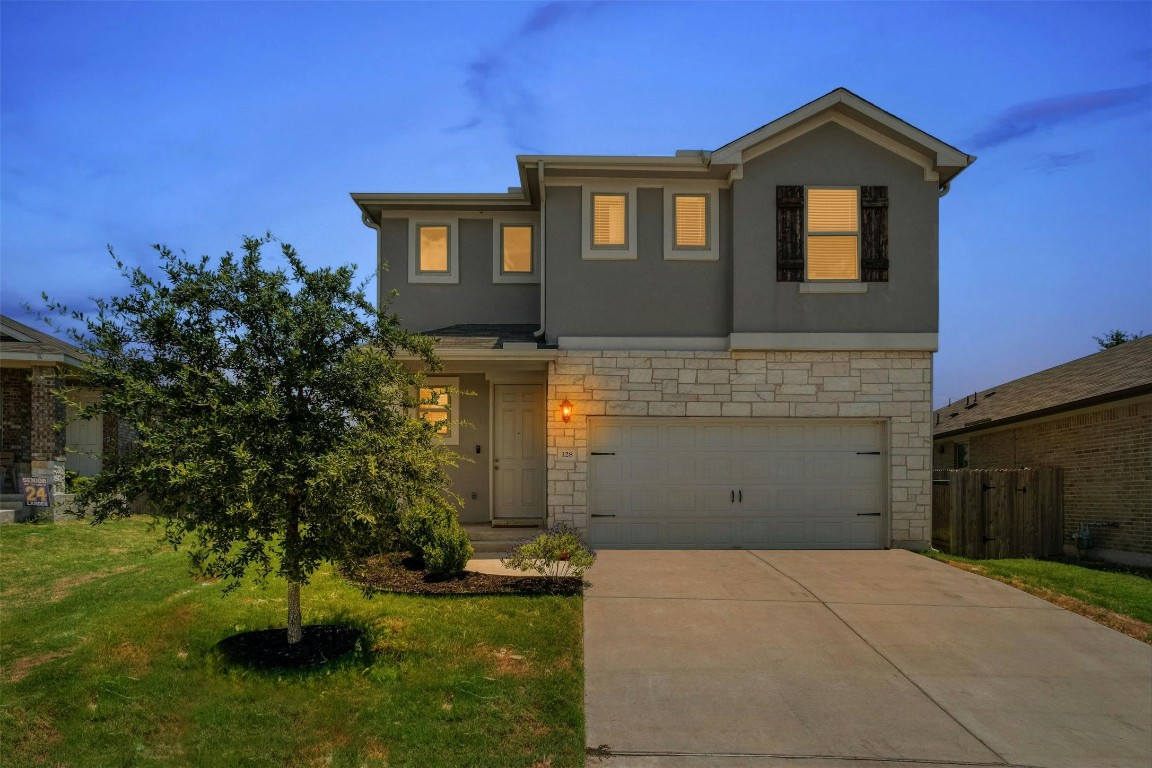128 Tucana Street Georgetown, TX 78628 - Photo 1 of 1 a front view of a house with a yard and garage