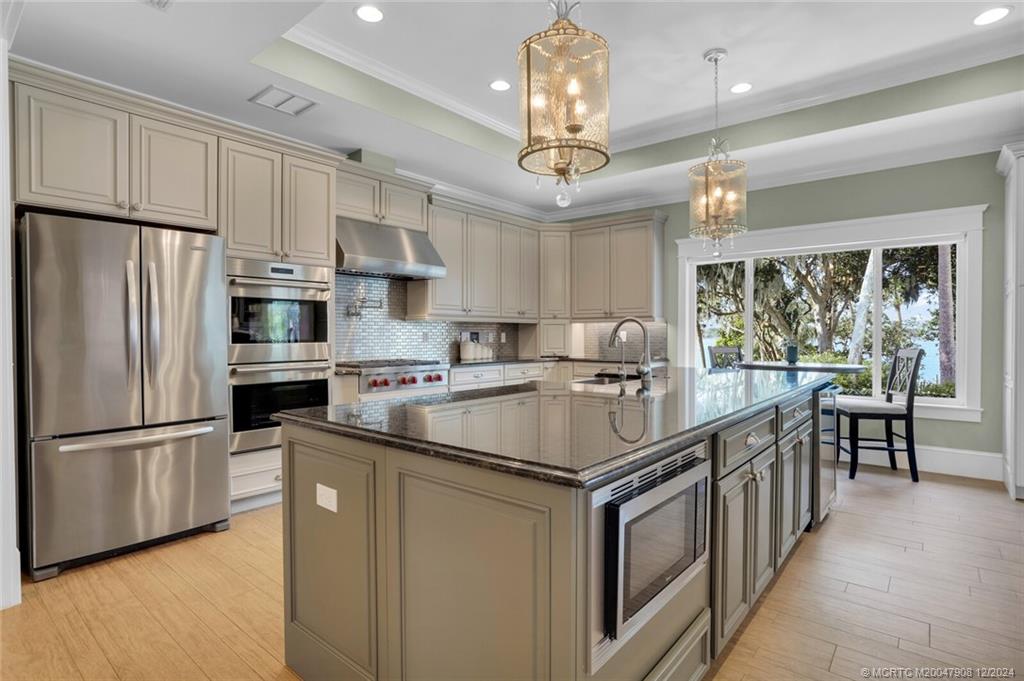 51 North River Road Stuart, FL 34996 - Photo 11 of 59 a kitchen with stainless steel appliances a sink stove and refrigerator
