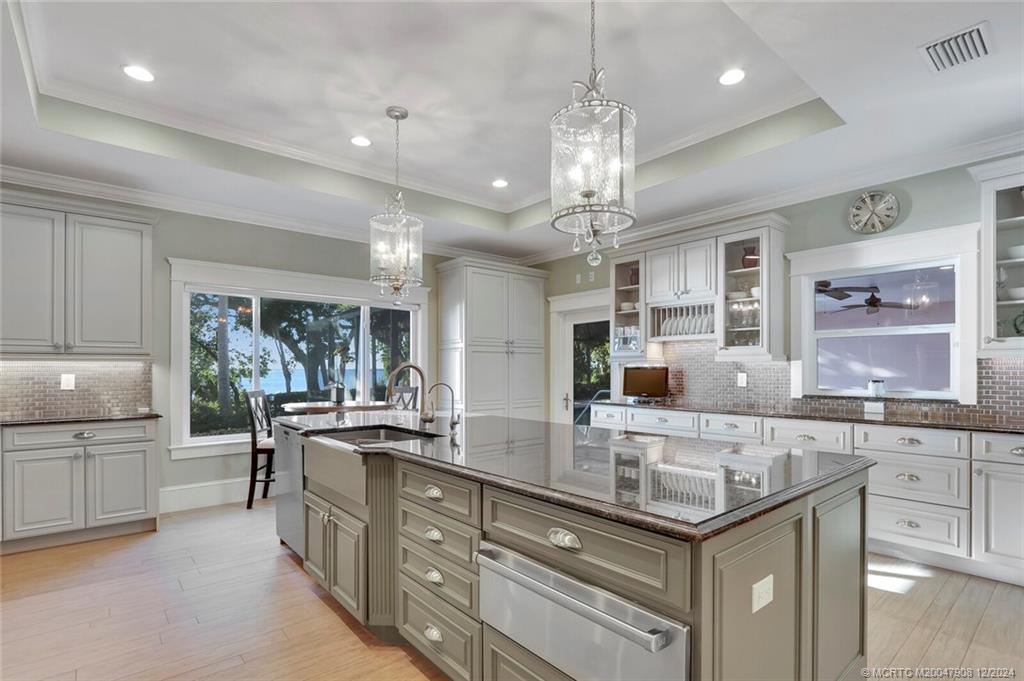 51 North River Road Stuart, FL 34996 - Photo 14 of 59 a large kitchen with granite countertop a large island in the center and stainless steel appliances