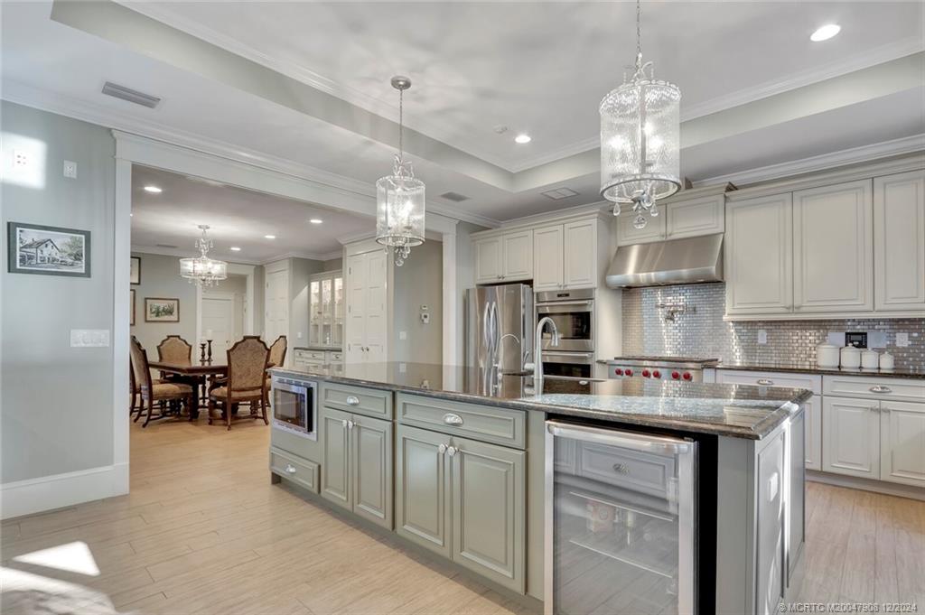 51 North River Road Stuart, FL 34996 - Photo 15 of 59 a large kitchen with cabinets chairs and chairs