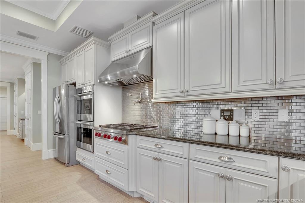 51 North River Road Stuart, FL 34996 - Photo 17 of 59 a kitchen with stainless steel appliances granite countertop a sink a stove and a refrigerator