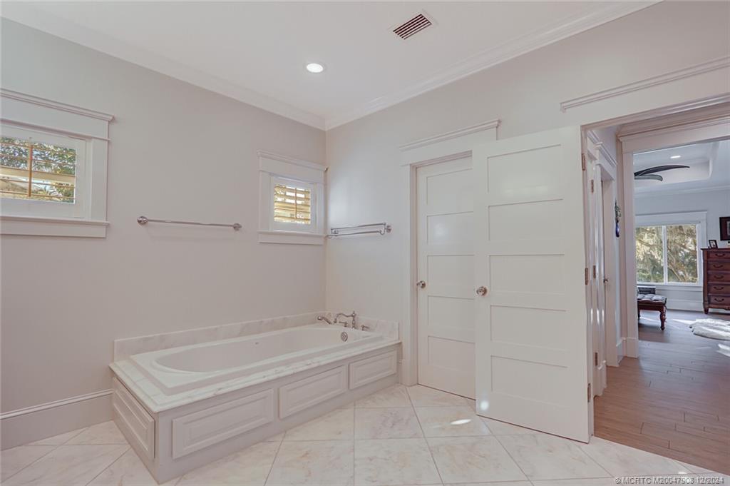 51 North River Road Stuart, FL 34996 - Photo 23 of 59 a spacious bathroom with a tub shower and yard