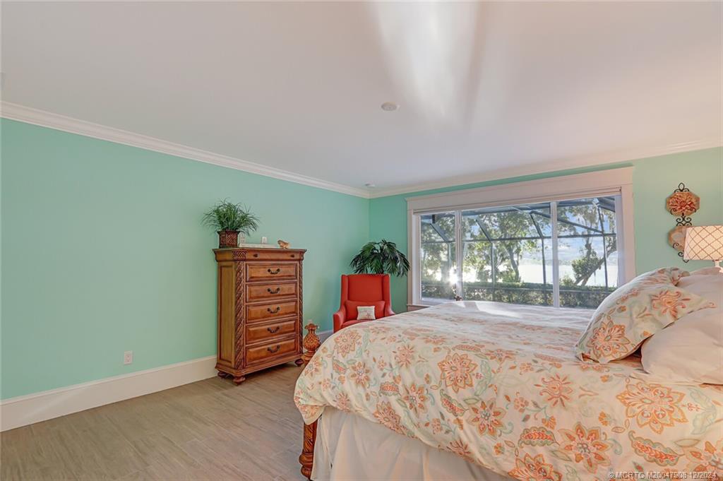 51 North River Road Stuart, FL 34996 - Photo 25 of 59 a bedroom with a bed and a dresser next to a window