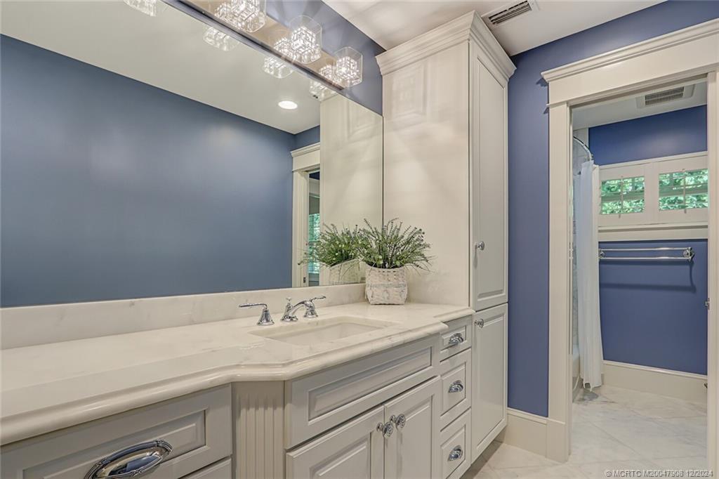 51 North River Road Stuart, FL 34996 - Photo 29 of 59 a bathroom with a sink and a mirror
