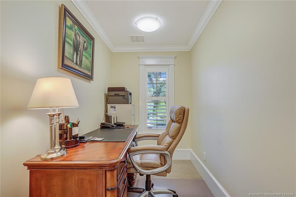 51 North River Road Stuart, FL 34996 - Photo 30 of 59 a view of a workspace with furniture and a chandelier
