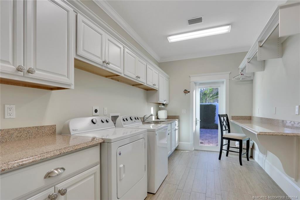 51 North River Road Stuart, FL 34996 - Photo 31 of 59 a kitchen with stainless steel appliances granite countertop a sink dishwasher stove and cabinets with wooden floor