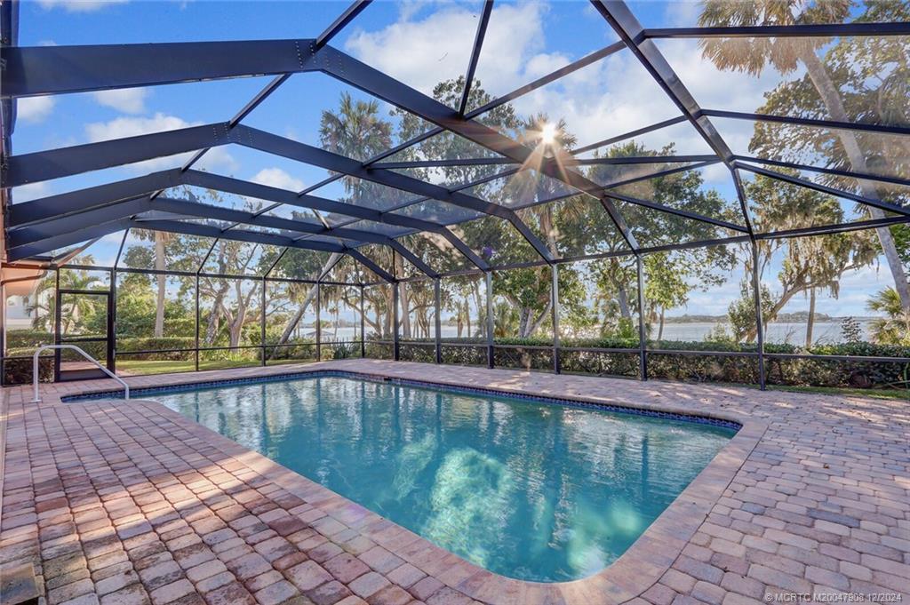 51 North River Road Stuart, FL 34996 - Photo 35 of 59 a view of a swimming pool with a patio