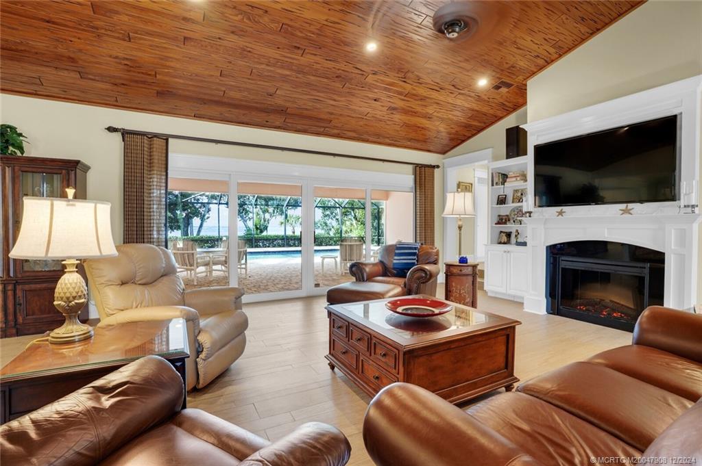 51 North River Road Stuart, FL 34996 - Photo 4 of 59 a living room with furniture fireplace and a flat screen tv