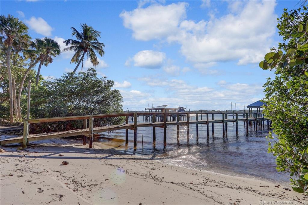 51 North River Road Stuart, FL 34996 - Photo 44 of 59 a view of a terrace with a bench and floor to ceiling window