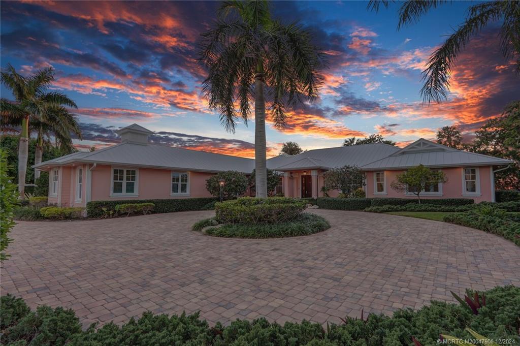 51 North River Road Stuart, FL 34996 - Photo 48 of 59 a front view of a house with a garden