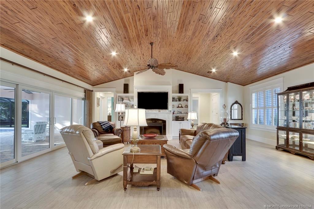 51 North River Road Stuart, FL 34996 - Photo 5 of 59 a living room with furniture a fireplace and a flat screen tv