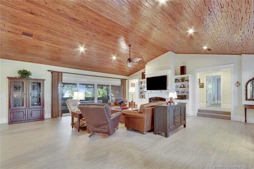 51 North River Road Stuart, FL 34996 - Photo 6 of 59 a living room with furniture and large flat screen tv