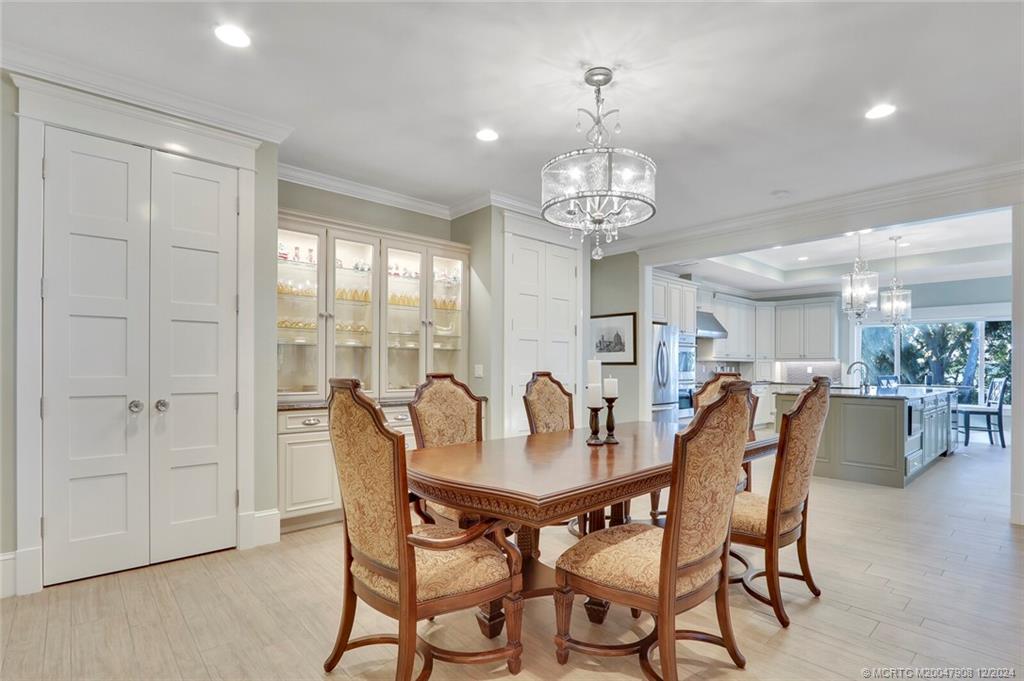 51 North River Road Stuart, FL 34996 - Photo 9 of 59 a view of a dining room with furniture wooden floor and chandelier