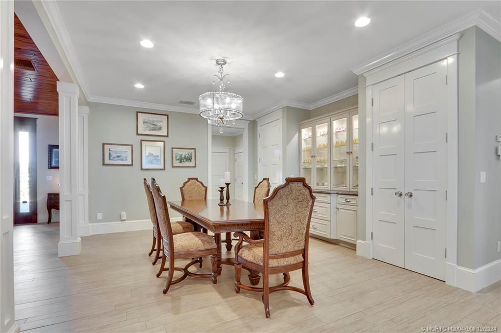 51 North River Road Stuart, FL 34996 - Photo 10 of 59 a view of a dining room with furniture and wooden floor