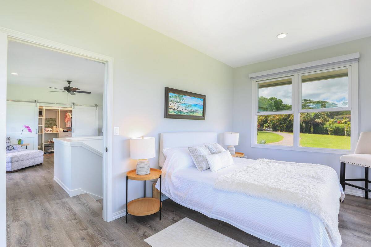 4858 Kahiliholo Road, Unit #3 Kilauea, HI 96754 - Photo 12 of 22 a bedroom with a bed and wooden floor