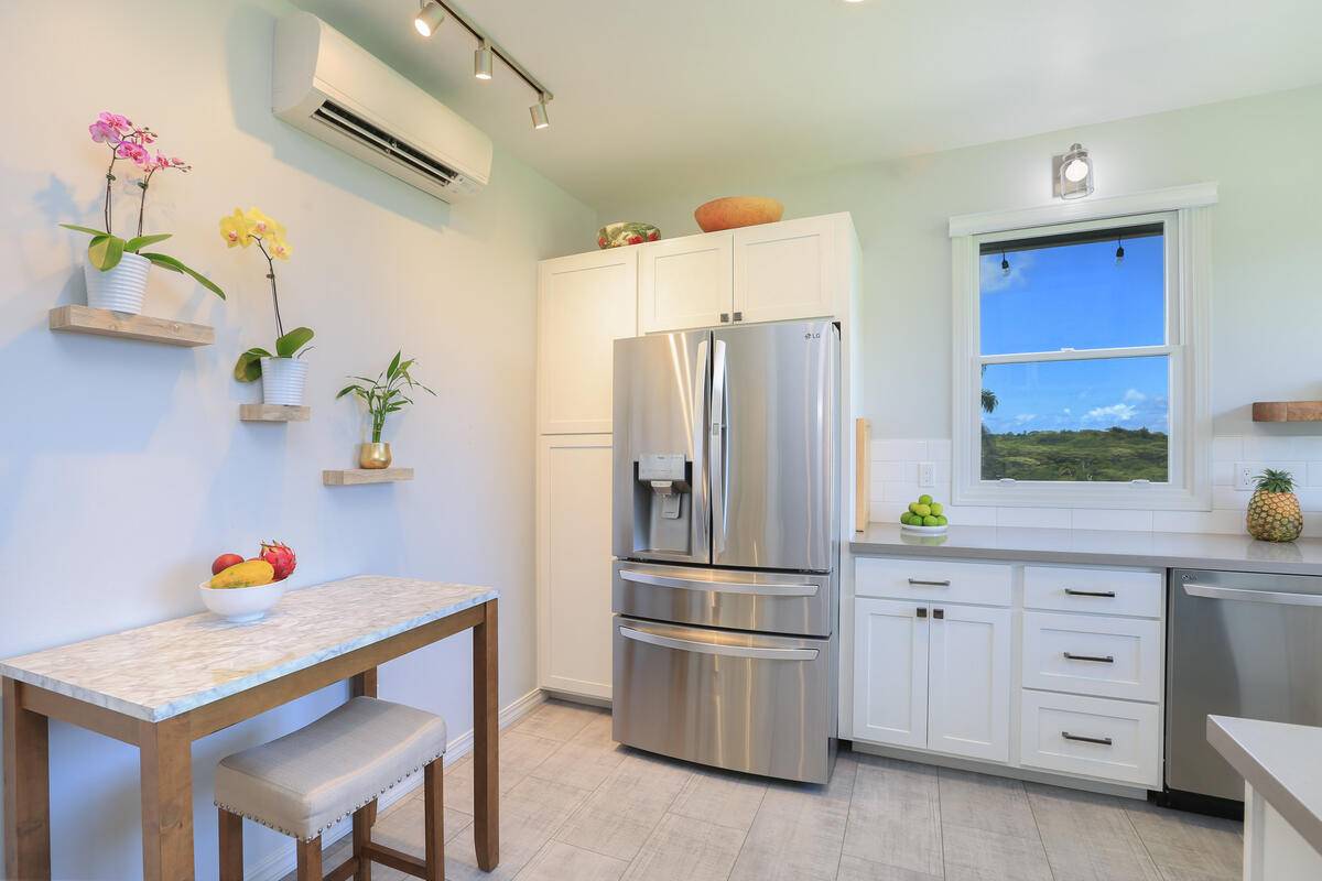 4858 Kahiliholo Road, Unit #3 Kilauea, HI 96754 - Photo 14 of 22 a kitchen with refrigerator and cabinets