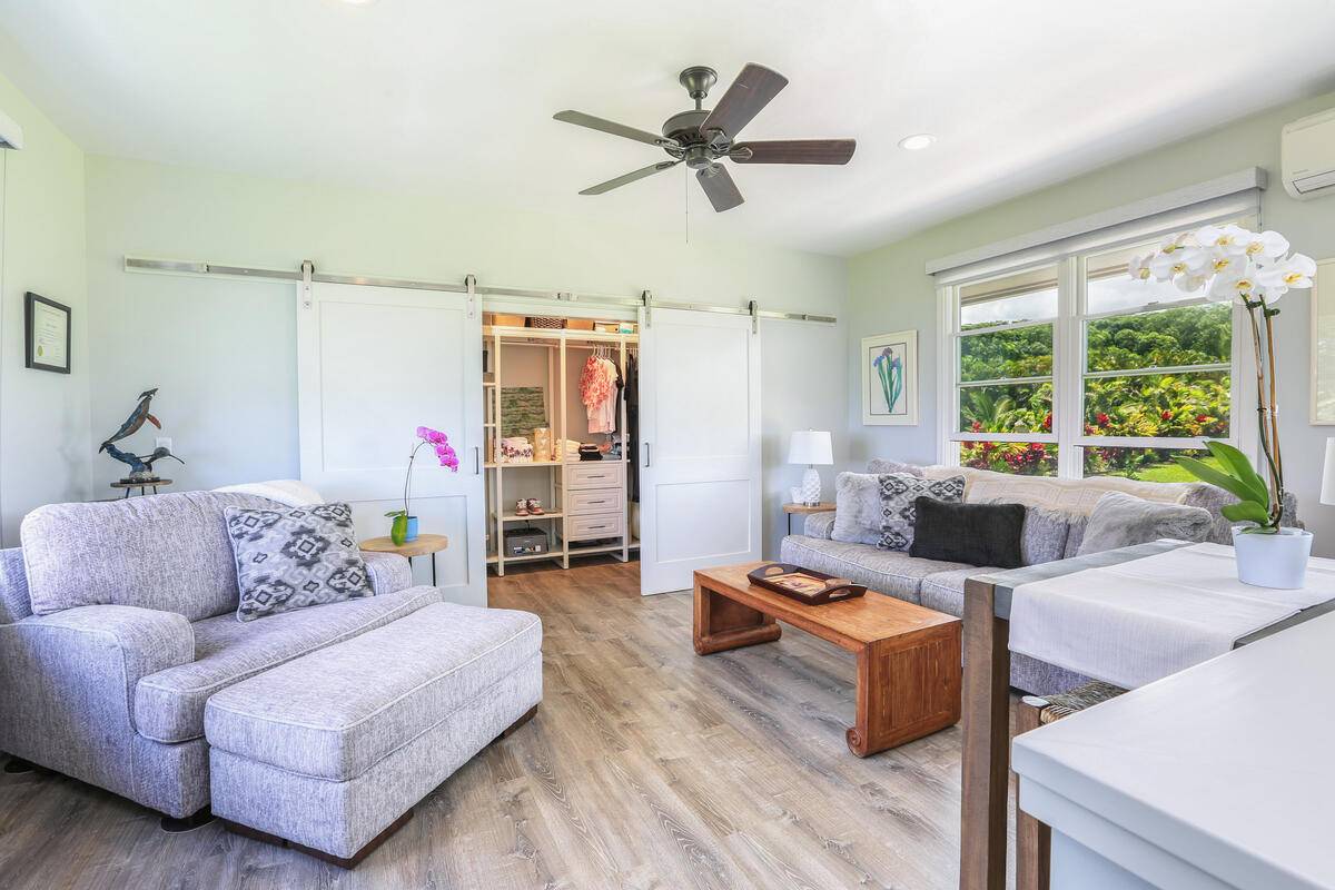 4858 Kahiliholo Road, Unit #3 Kilauea, HI 96754 - Photo 5 of 22 a living room with furniture and a large window