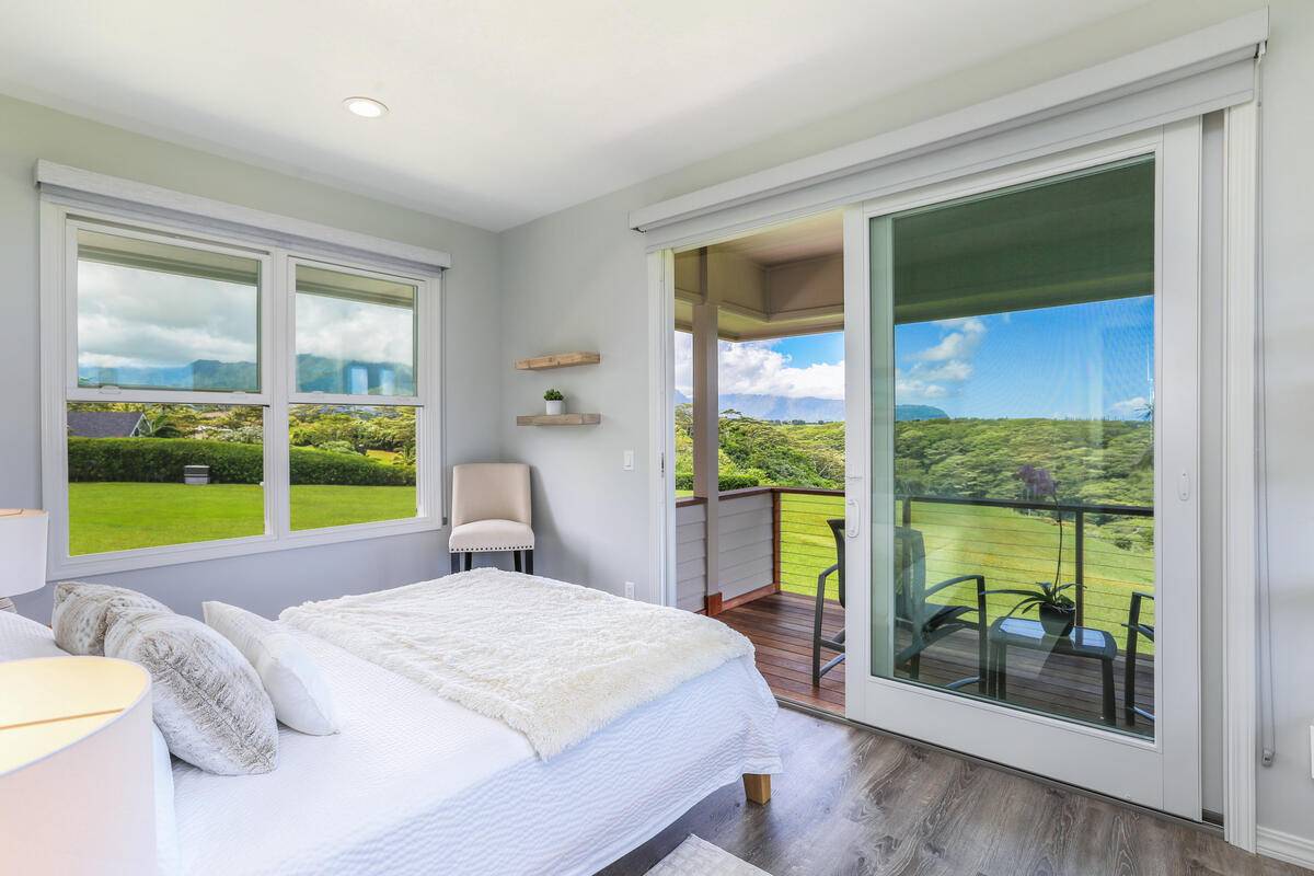 4858 Kahiliholo Road, Unit #3 Kilauea, HI 96754 - Photo 8 of 22 a bedroom with a large window and a bed