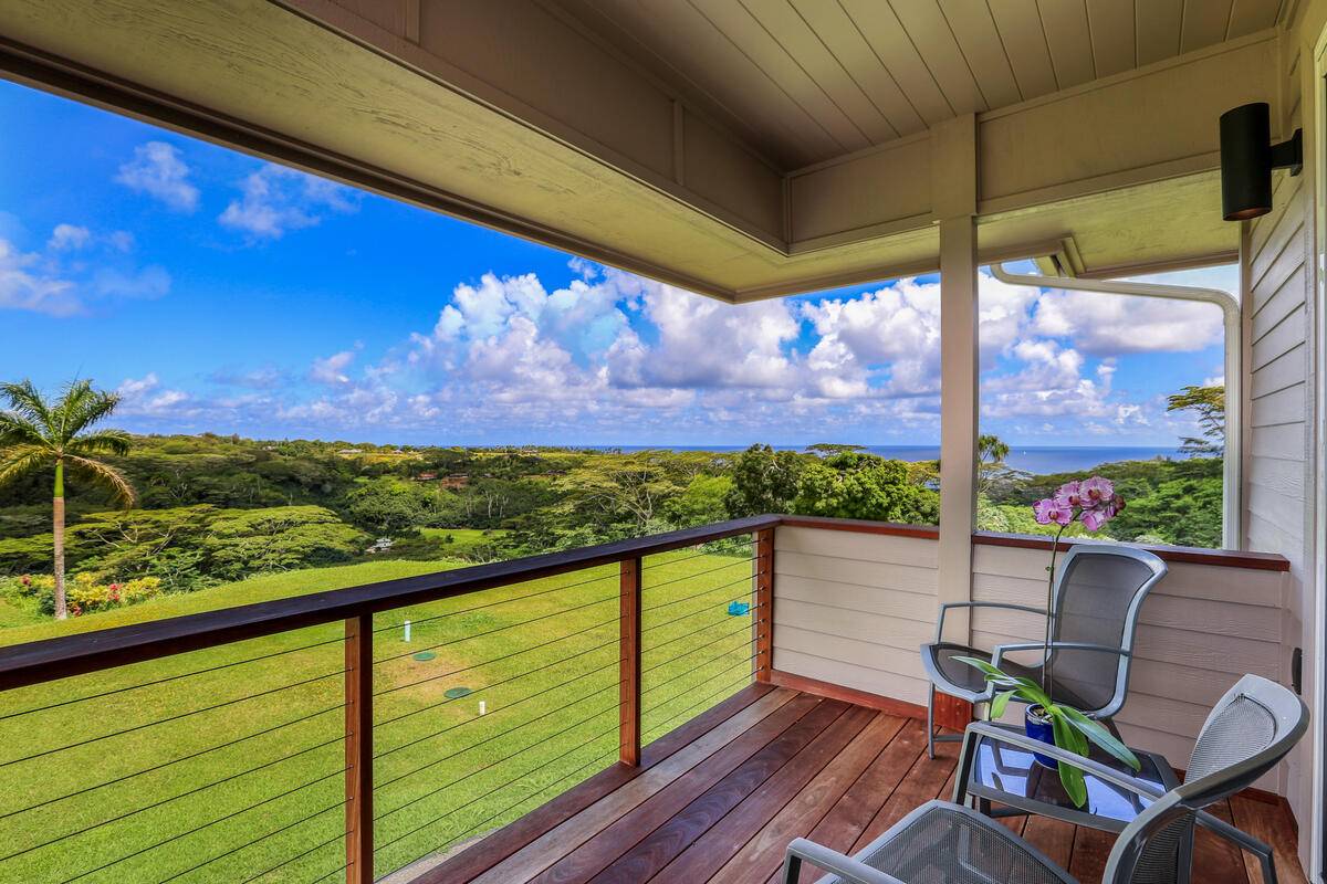 4858 Kahiliholo Road, Unit #3 Kilauea, HI 96754 - Photo 9 of 22 a view of a chairs and table in patio with a wooden fence
