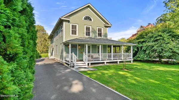 a front view of a house with a yard and porch