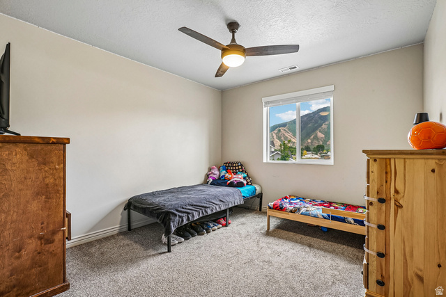 203 North 1900th Street West Mapleton, UT 84664 - Photo 24 of 48 Window featuring mountain scenery, ceiling fan with integrated lighting, neutral wall tones, and gray carpeting