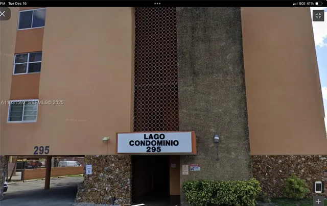 a sign board with a brick wall