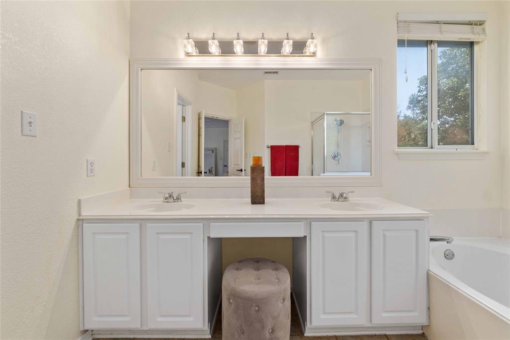 2730 Kinney Oaks Court Austin, TX 78704 - Photo 17 of 32 A spacious double vanity vanity area sits adjacent to a built-in soaking tub.