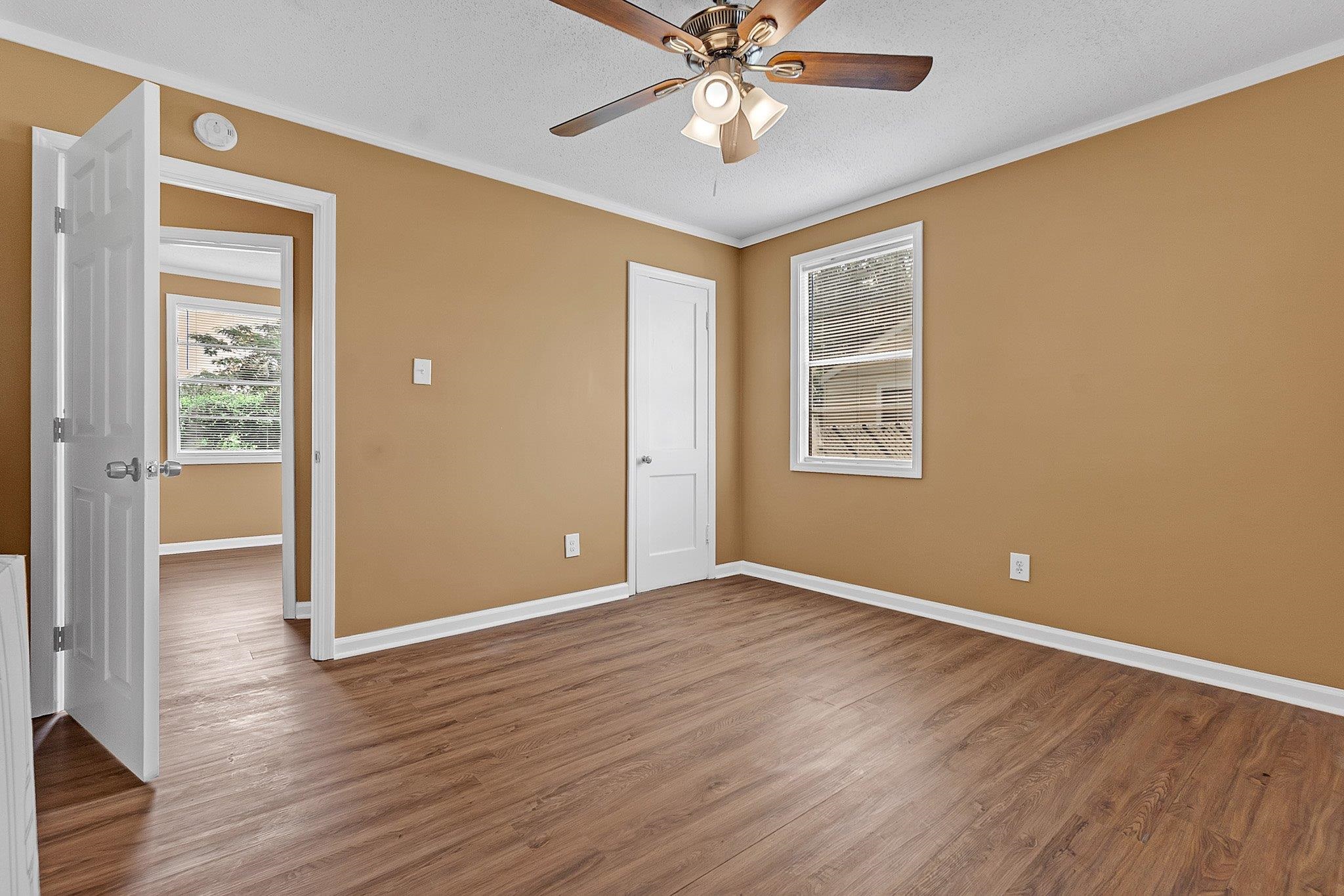 3186 Alta Road Memphis, TN 38109 - Photo 10 of 14 Interior room with wood-finish flooring, a ceiling fan with integrated lighting, and a white-trimmed window