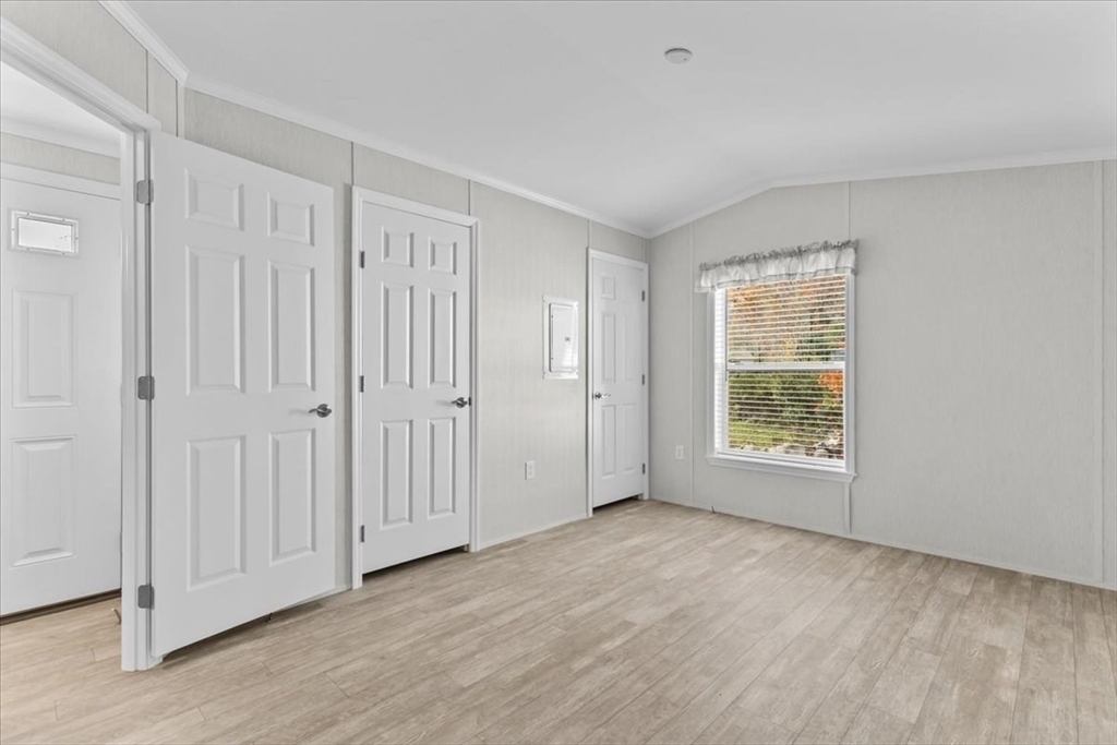 1540 Broadway, Unit 35 Raynham, MA 02767 - Photo 16 of 21 an empty room with wooden floor and windows