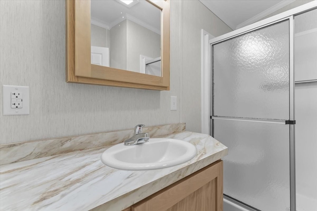 1540 Broadway, Unit 35 Raynham, MA 02767 - Photo 17 of 21 a bathroom with a sink and a mirror