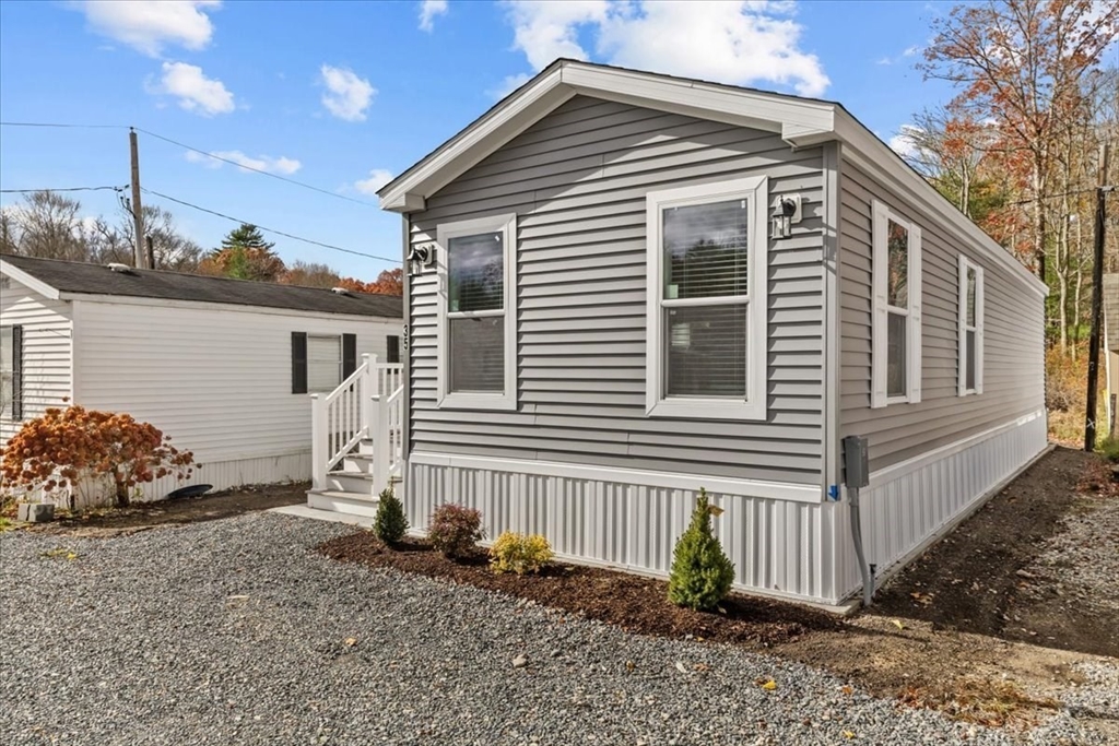 1540 Broadway, Unit 35 Raynham, MA 02767 - Photo 2 of 21 a front view of a house with garden