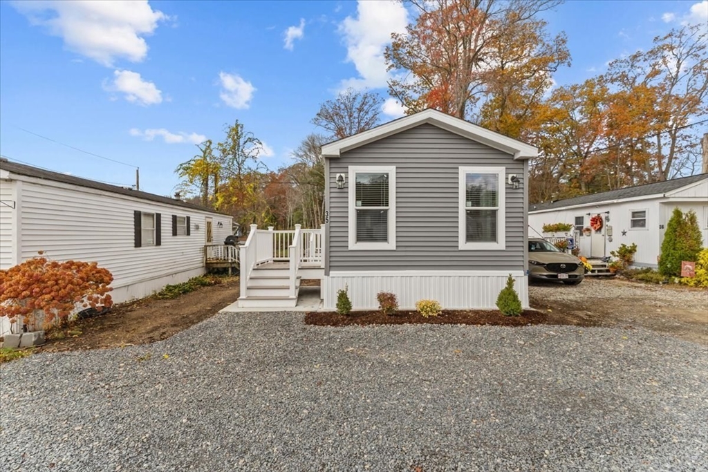 1540 Broadway, Unit 35 Raynham, MA 02767 - Photo 3 of 21 a view of a house with a yard