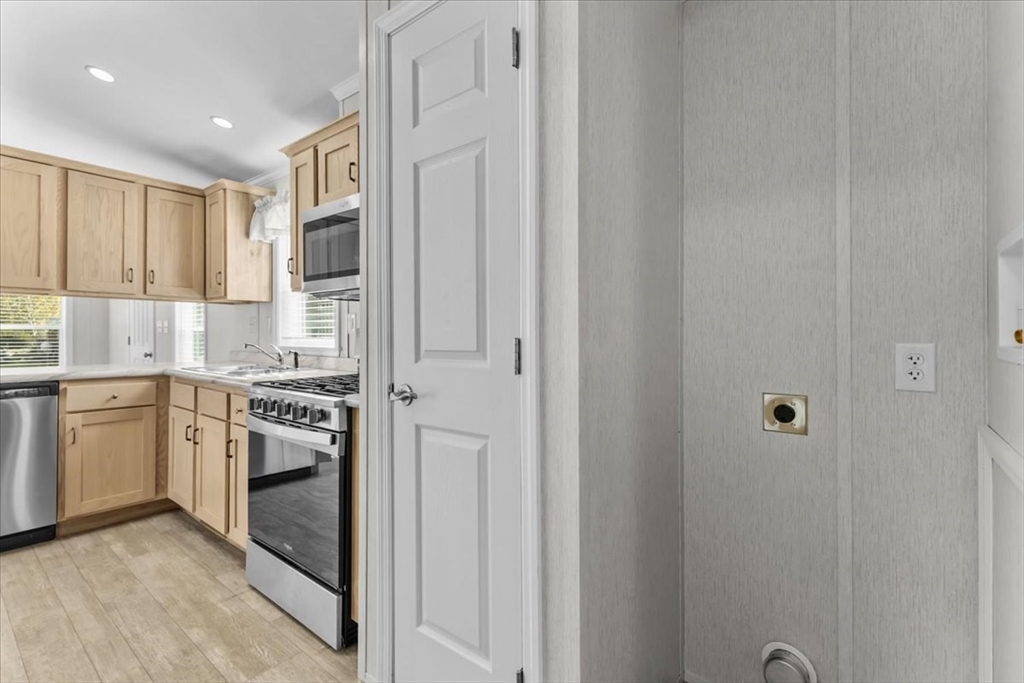 1540 Broadway, Unit 35 Raynham, MA 02767 - Photo 6 of 21 a kitchen with cabinets and stainless steel appliances