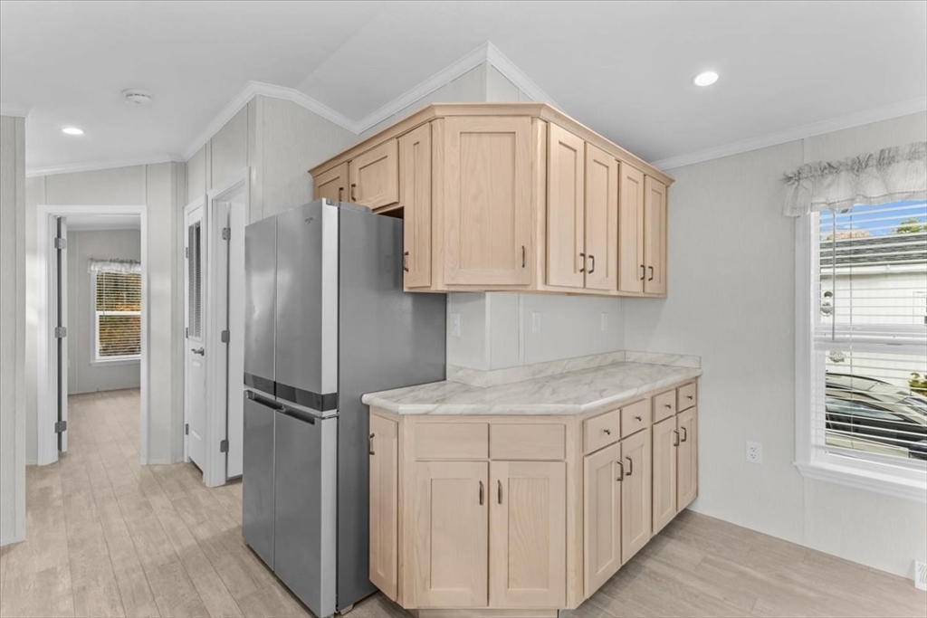 1540 Broadway, Unit 35 Raynham, MA 02767 - Photo 8 of 21 a kitchen with stainless steel appliances granite countertop a refrigerator and a sink