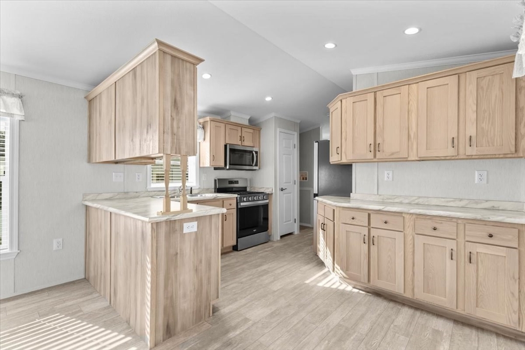 1540 Broadway, Unit 35 Raynham, MA 02767 - Photo 10 of 21 a kitchen with granite countertop white cabinets and white appliances