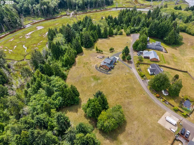 an aerial view of residential house with pool and garden