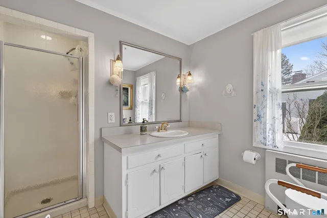 a spacious bathroom with a granite countertop sink and a mirror