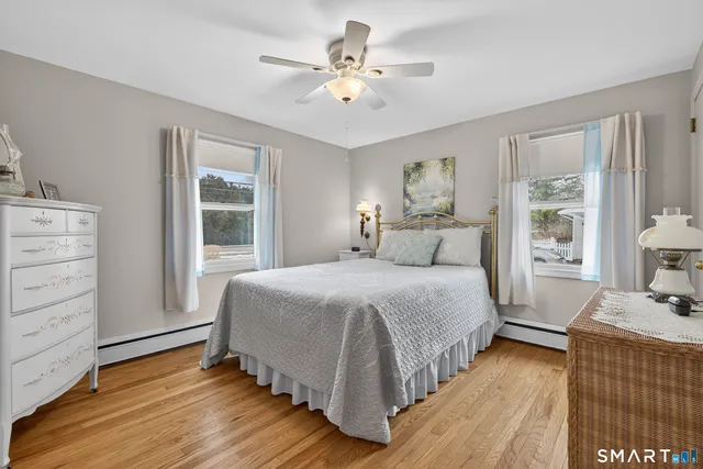 a bedroom with a bed and a view of ceiling fan