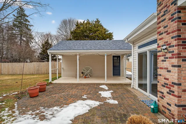 a view of a house with backyard and sitting area