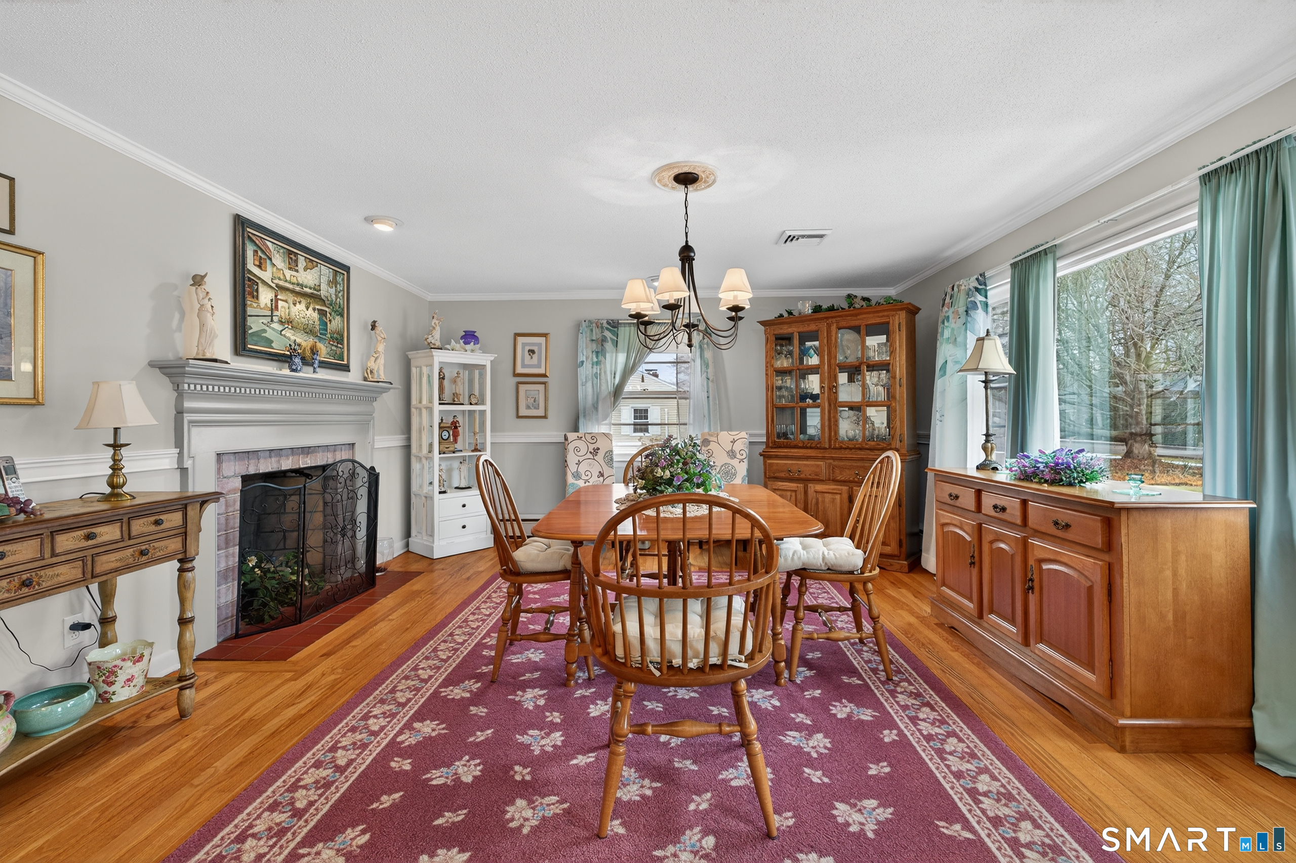 103 Maple Avenue Old Saybrook, CT 06475 - Photo 4 of 34 a living room with furniture a fireplace and a dining table