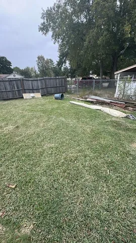 a backyard of a house with lots of green space and lake view